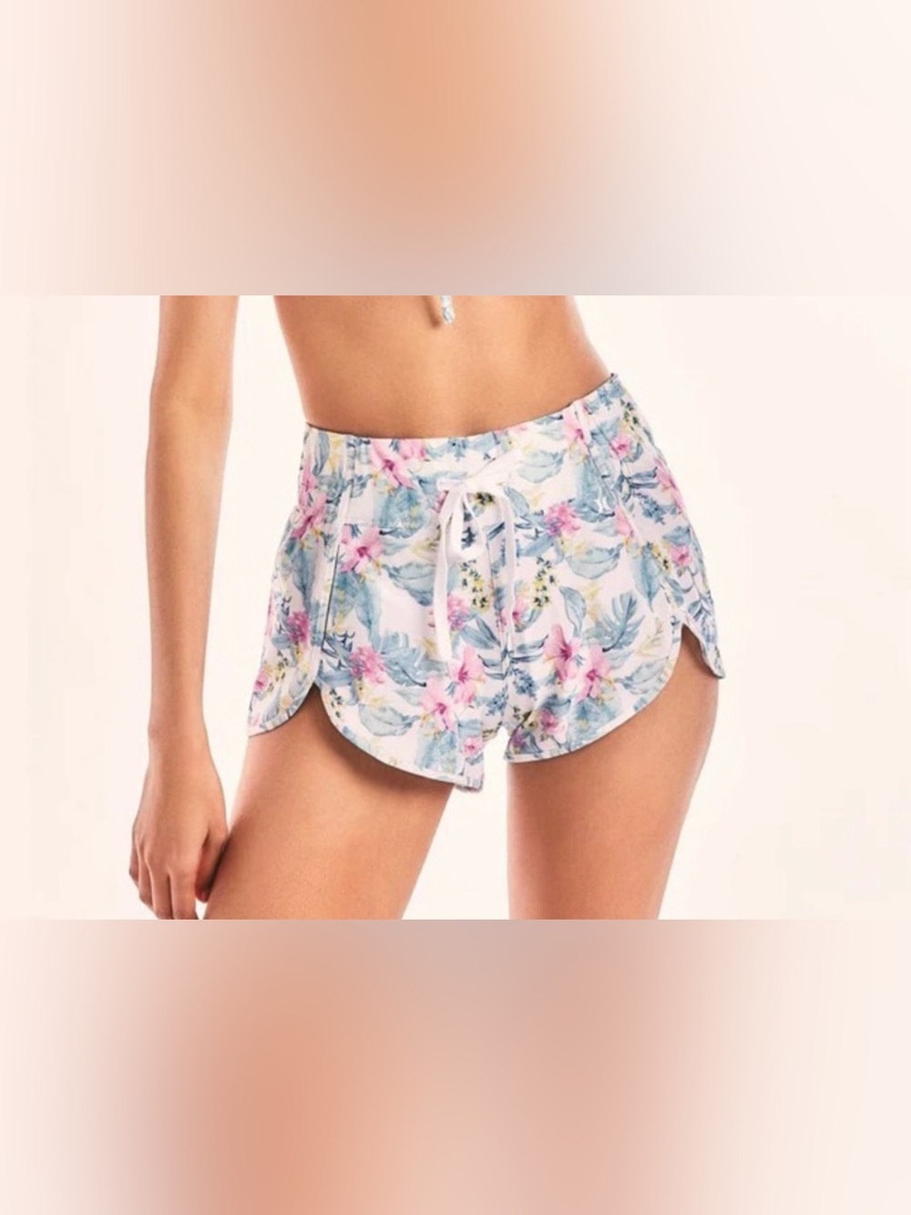 LoveShackFancy x Hurley floral board shorts feature a pink & blue hibiscus print